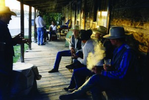 The historic OW bunkhouse porch is the perfect meeting spot for visiting ropers to gather after brandings for a fine cigar and a spot of single malt.